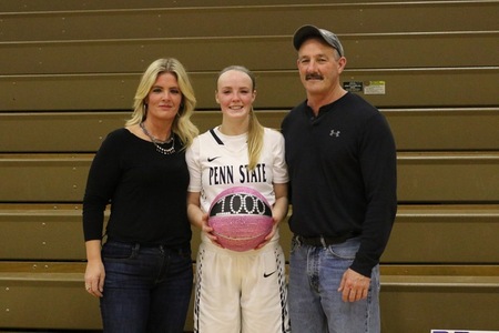 McKenzie Prutsman is flanked by her mother Tonia and father Eric after the game in which she scored her 1,000th career collegiate point.